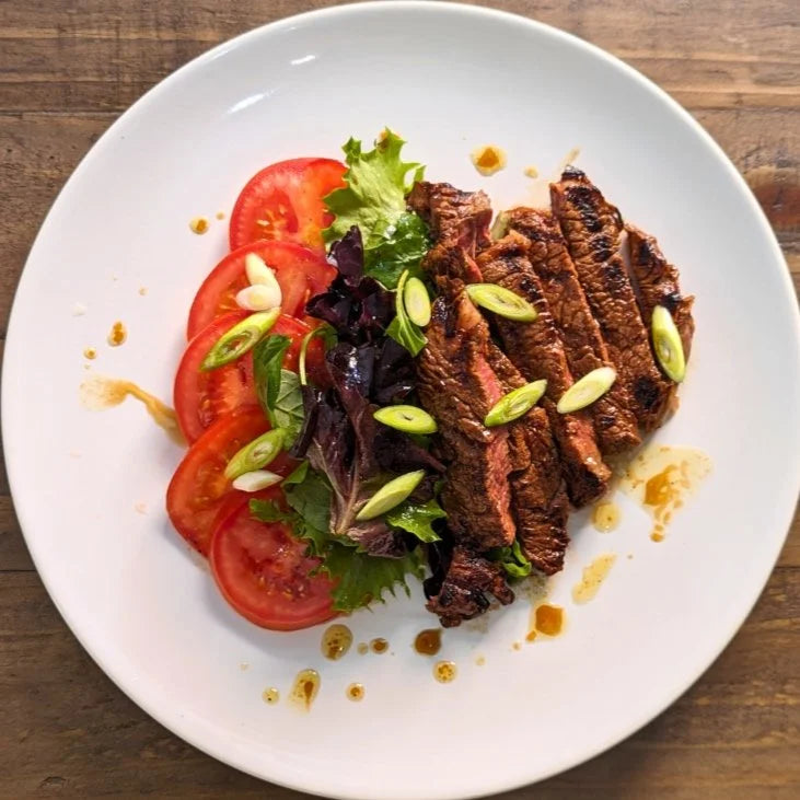 Steak marinade with tomato salad and soy dressing